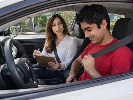 Driving instructor and student inside a car